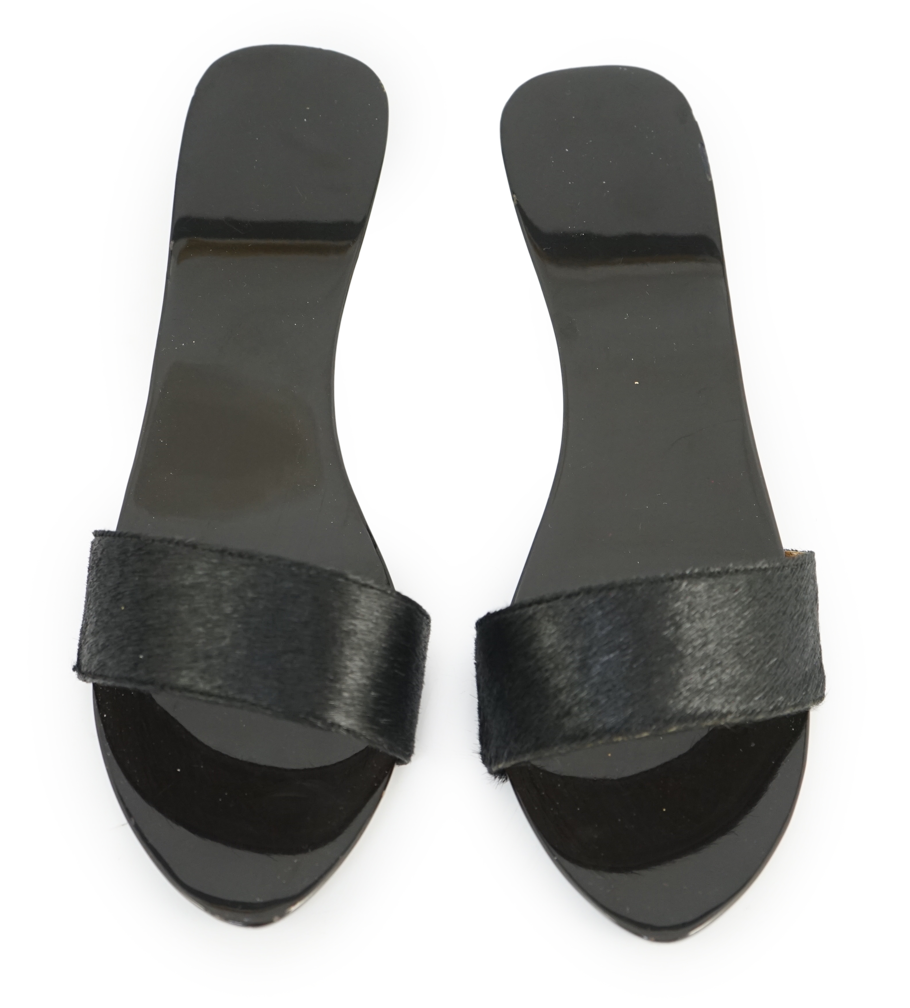 A pair of Hermès black pony skin and lacquer mules, Size 39